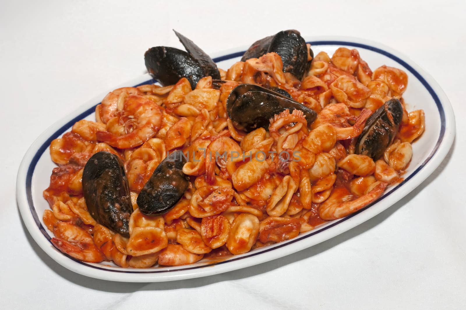 A dish of italian auricles with a seafood tomatoe sauce