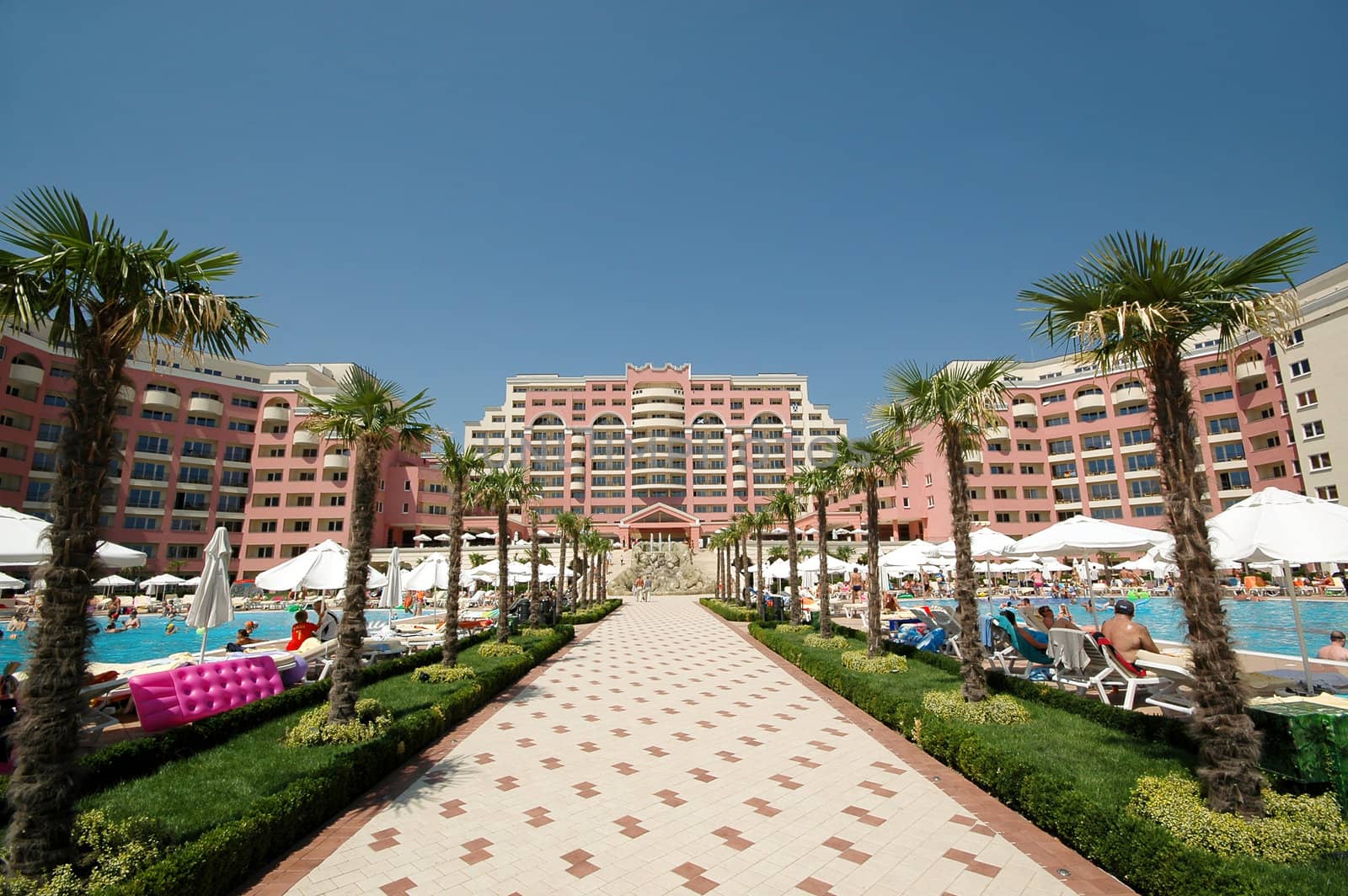 Hotel and pool area. Clear blue sky.