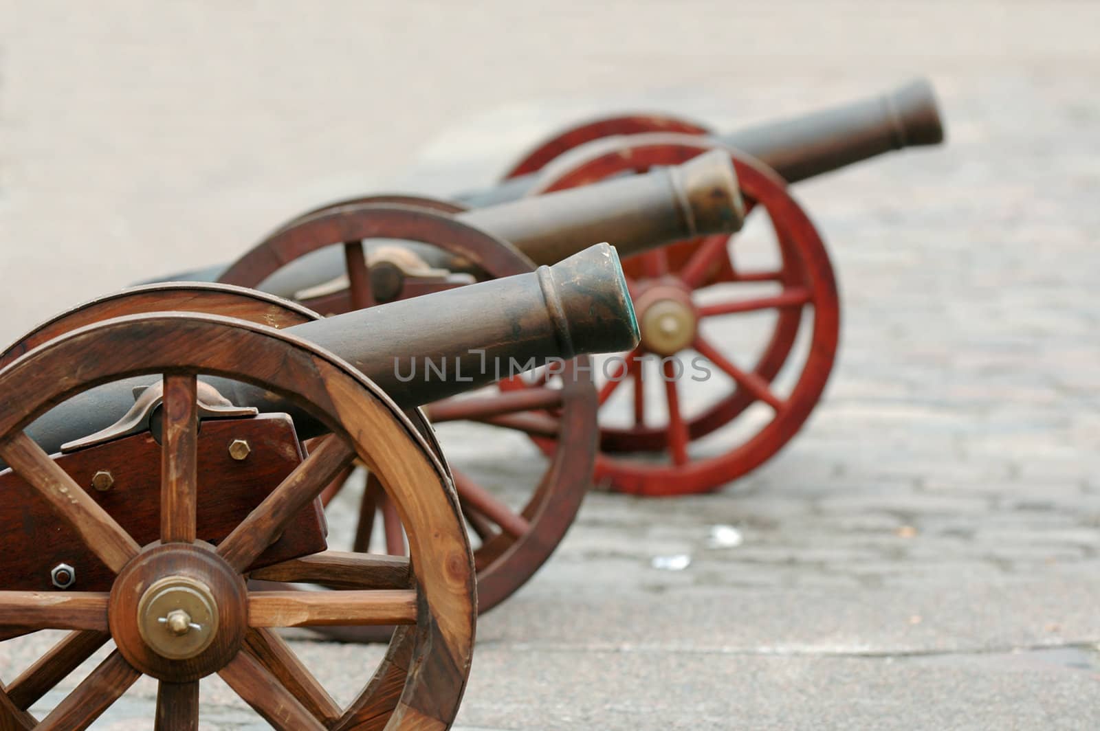 Three cannons are lined up for battle.