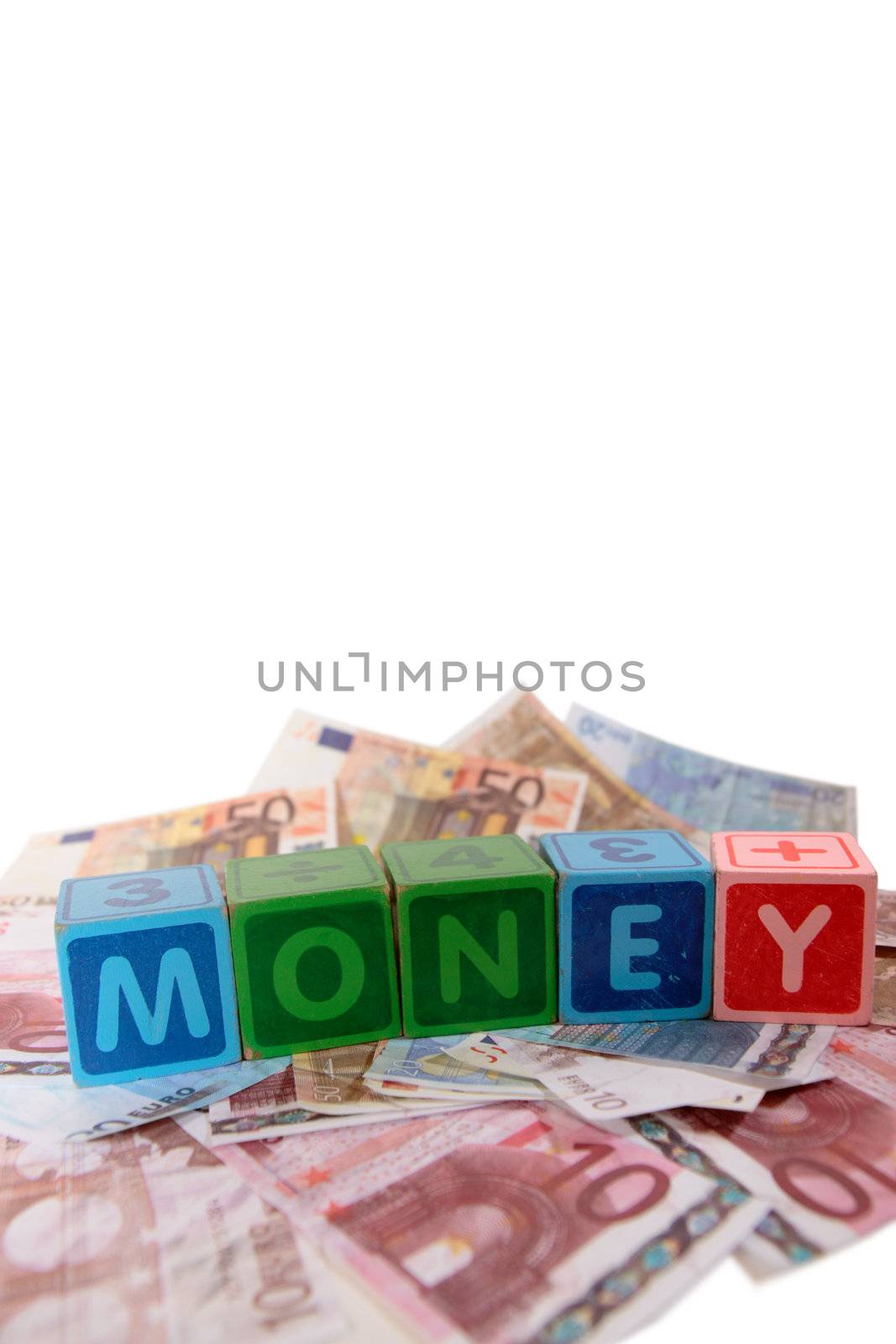 assorted childrens toy letter building blocks against a white background on money that spell money with copy space