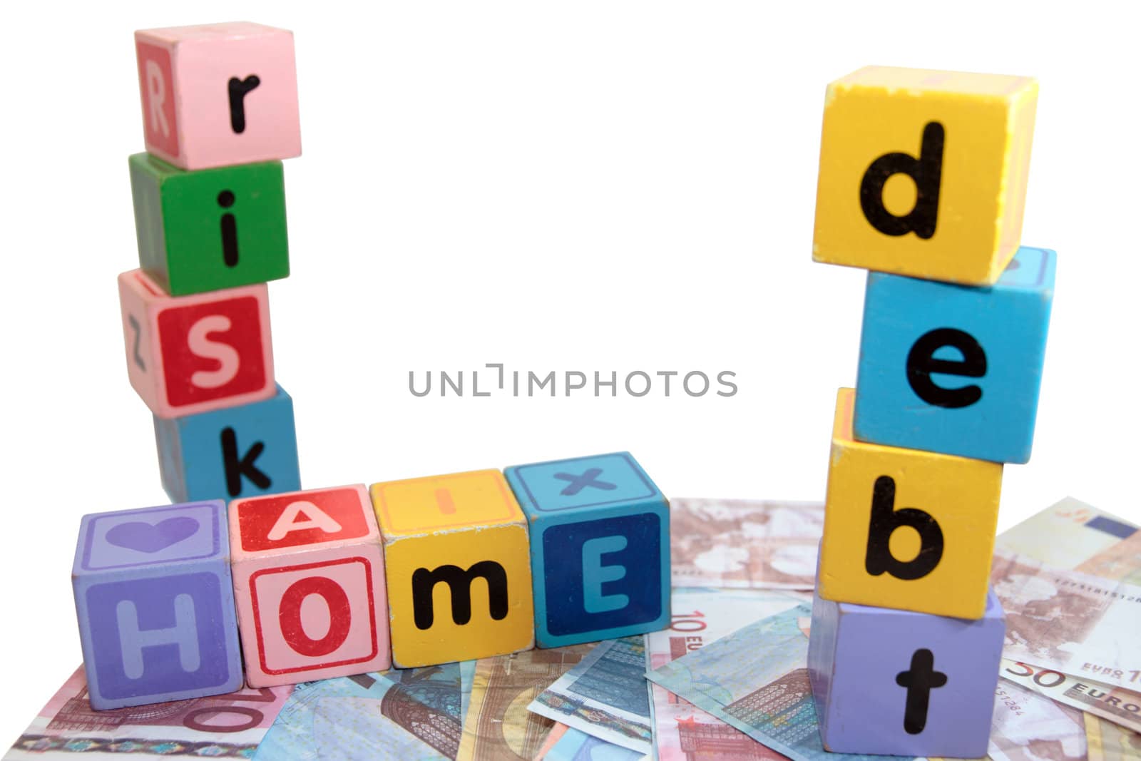 assorted childrens toy letter building blocks against a white background on money that spell home debt risk