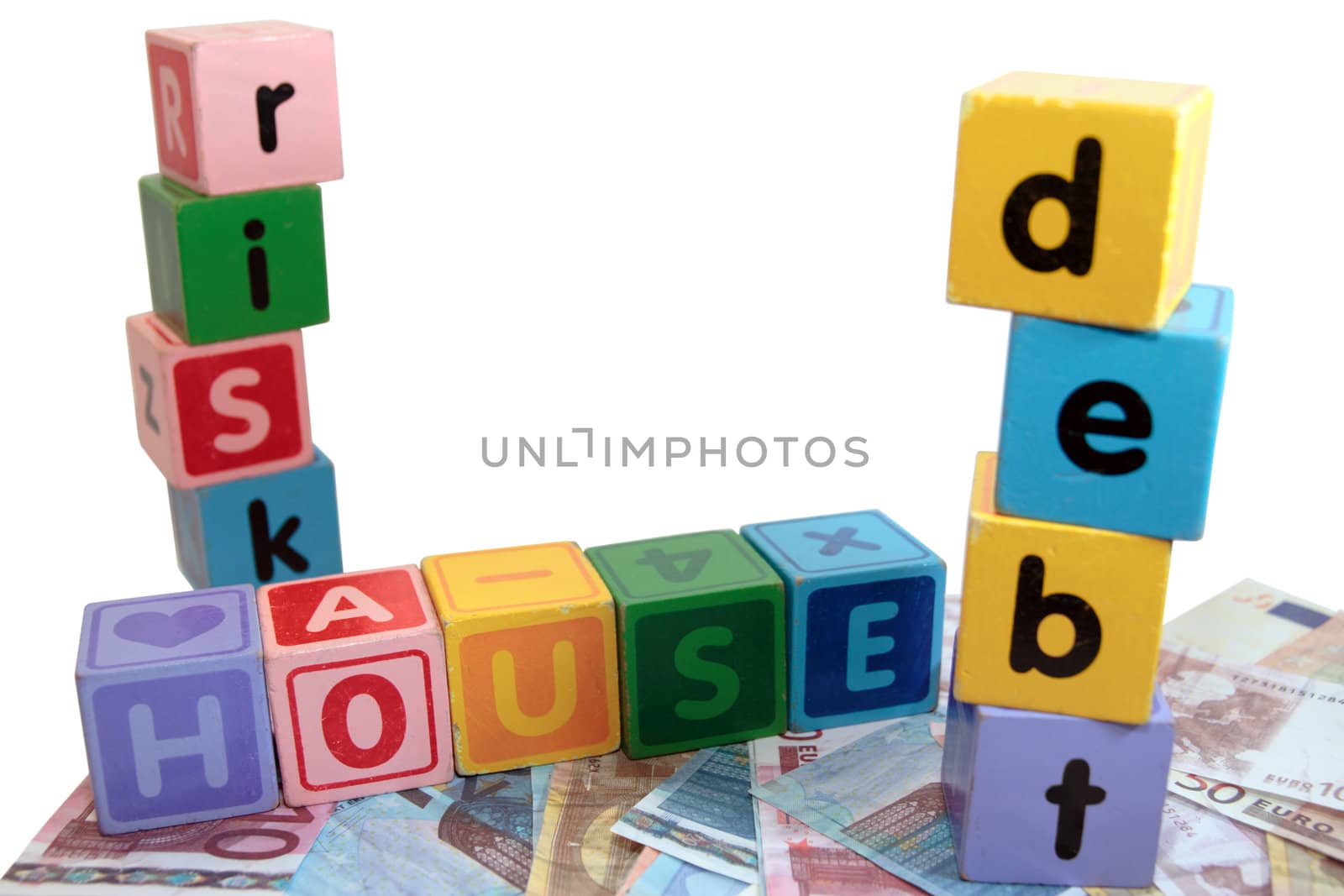 assorted childrens toy letter building blocks against a white background on money that spell house debt risk