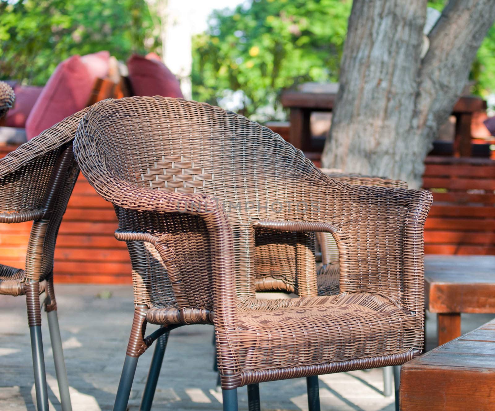 Wicker chairs are on the veranda of the summer cafe.