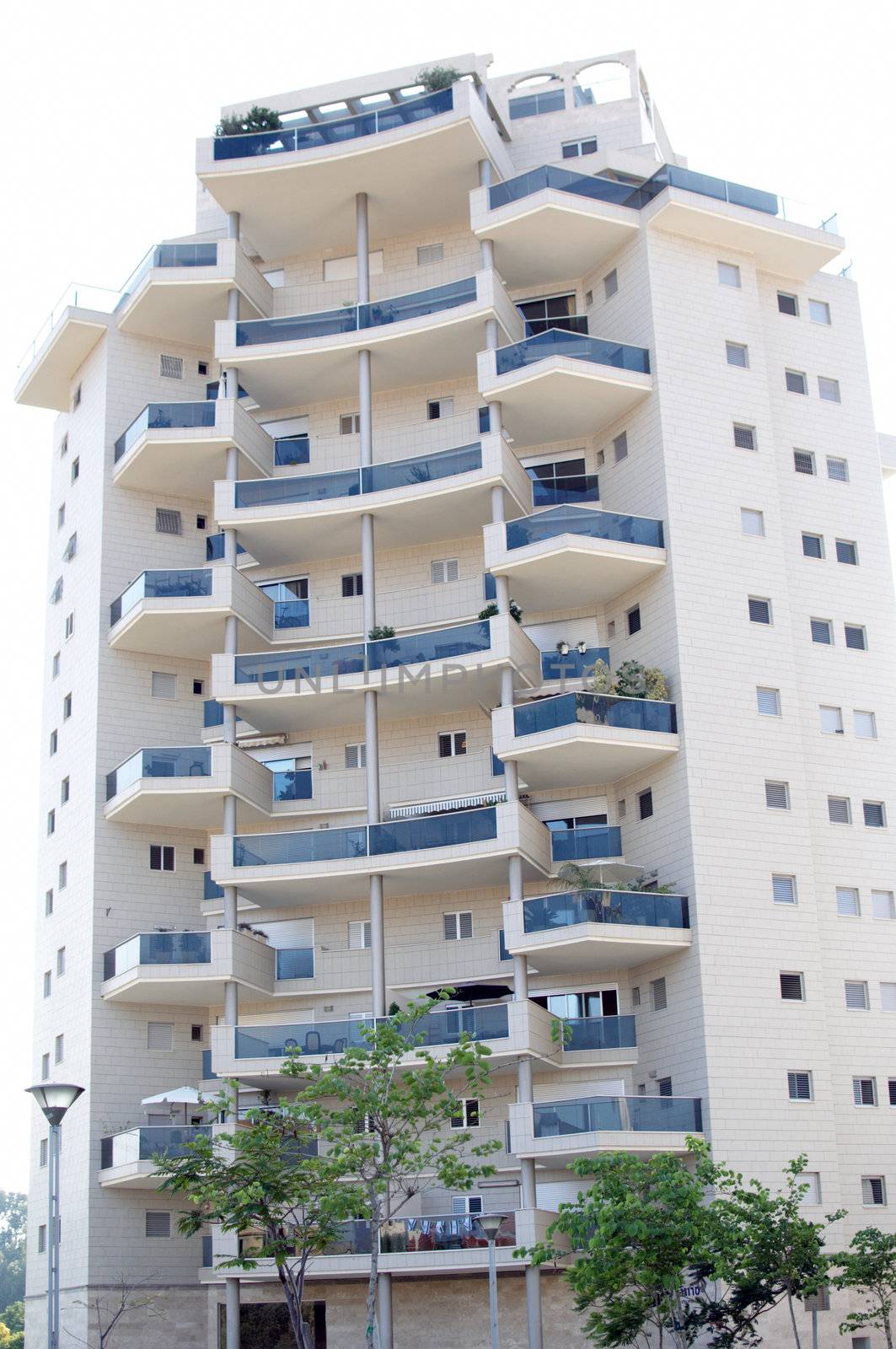 Front view urban apartment building with balconies .