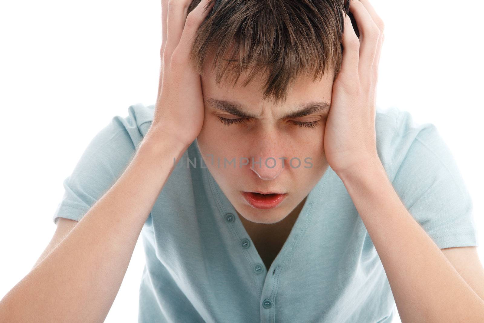 A teen boy showing signs of a headache, migrain or stress.