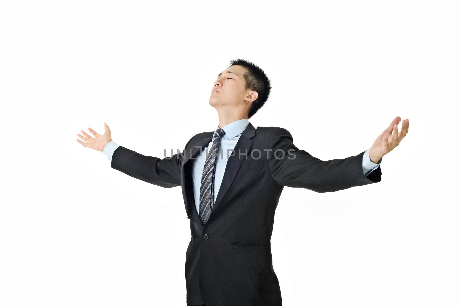 Businessman of freedom open arms and close eyes on white background.