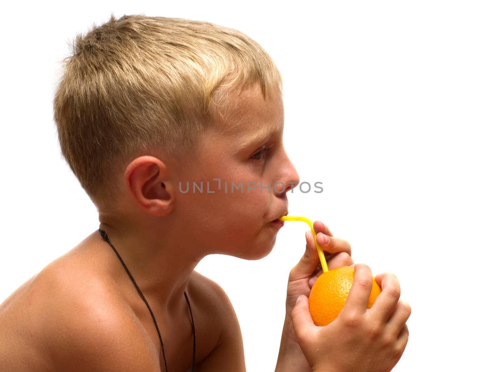 Boy drinking orange juice through straws isolated on a white background.
