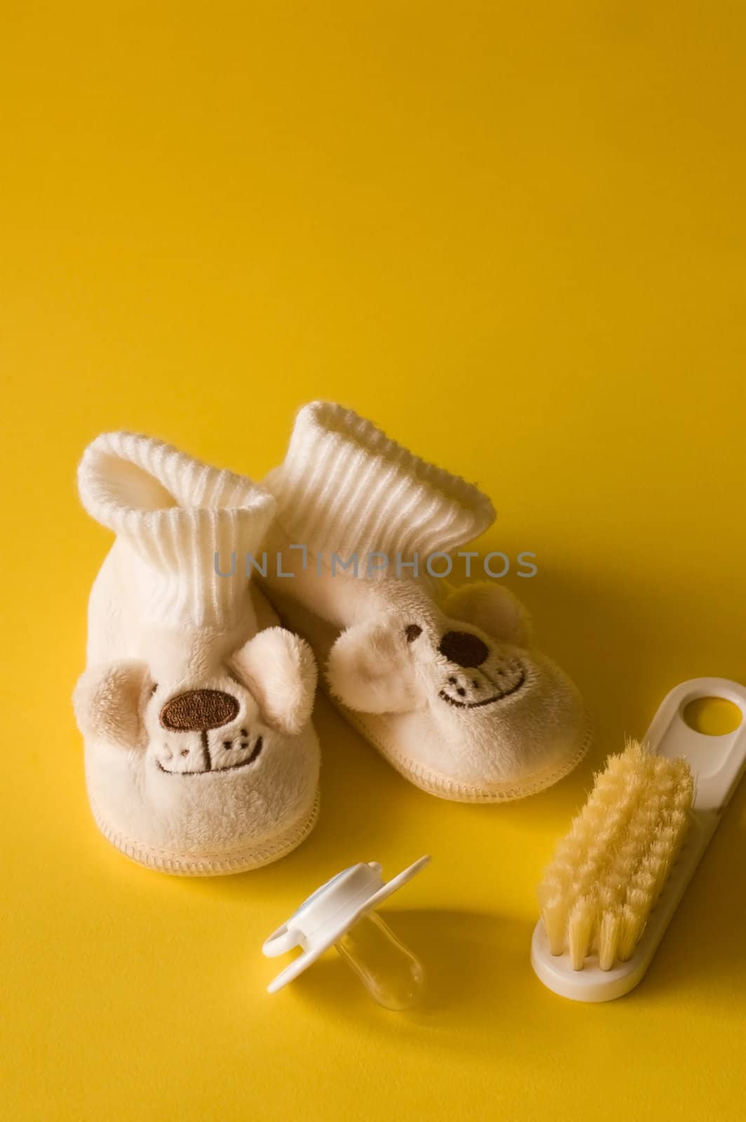 Essential children's accessories on yellow background , for each baby