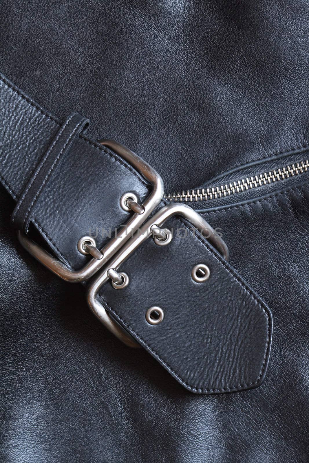 Closeup black leather background with belt and zipper