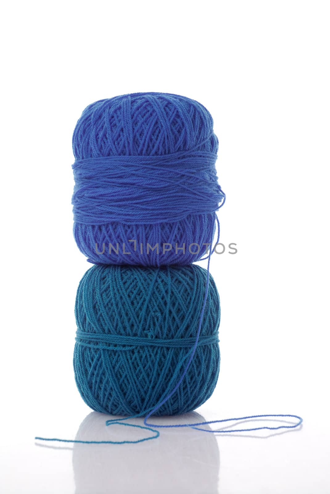 spools of cotton in blue tones on a white background.