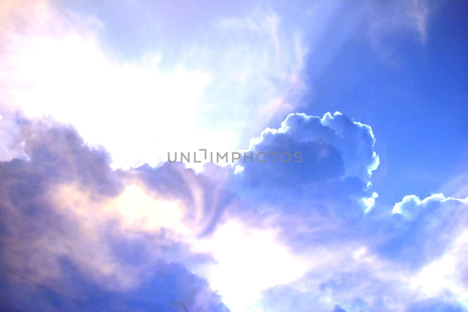 A background with a view of heavenly looking skies due to a strange formation of clouds and sunlight, in the evening.
