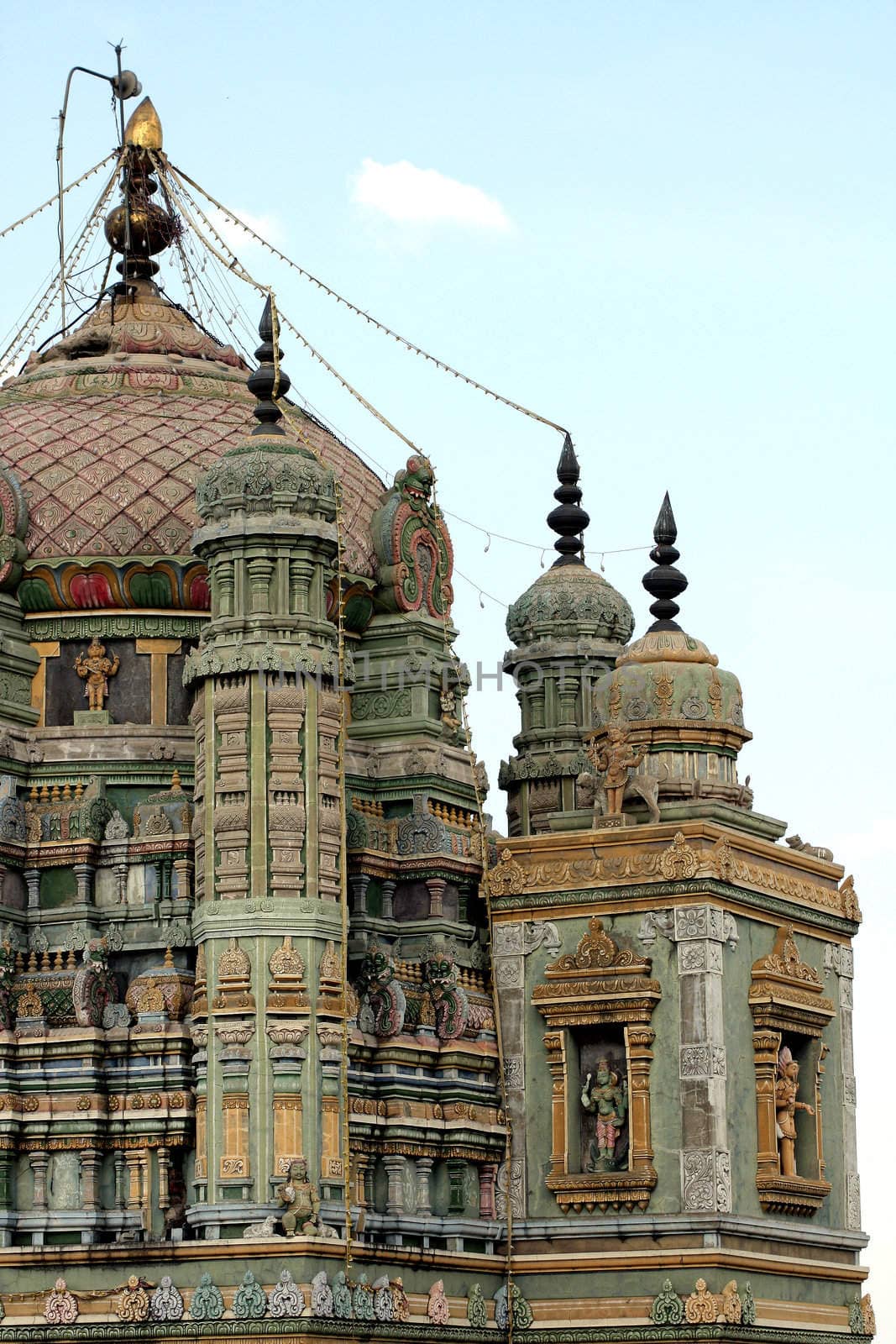 A dome of an ancient hindu temple in India with beautiful sculptures and artwork.