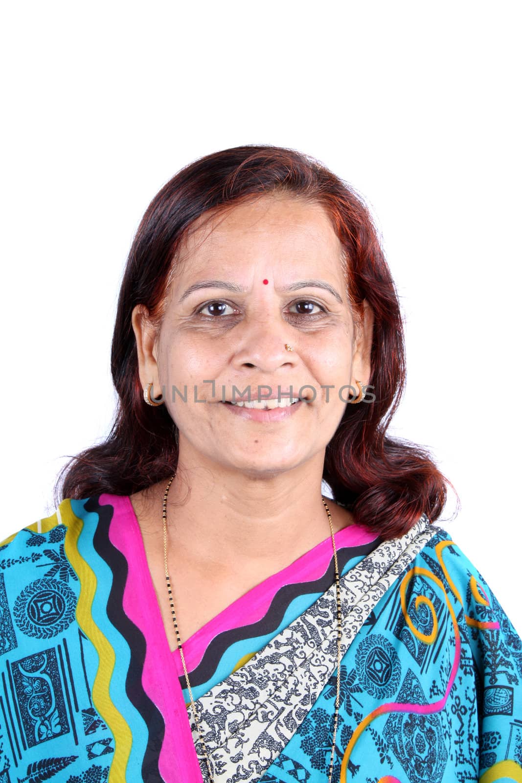 A portrait of a traditional middle-aged Indian woman from the Marwadi community in a sari, on white studio background.