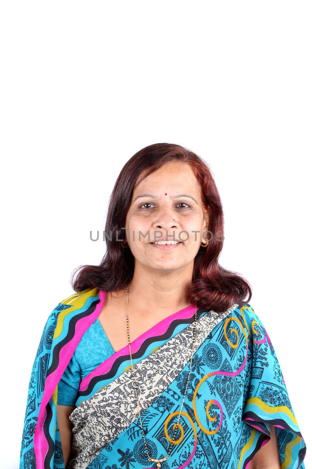 A portrait of a traditional middle-aged Indian woman in a sari, on white studio background.