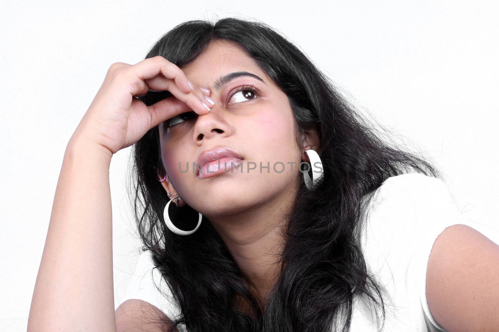 A portrait of a tensed Indian teenage girl.