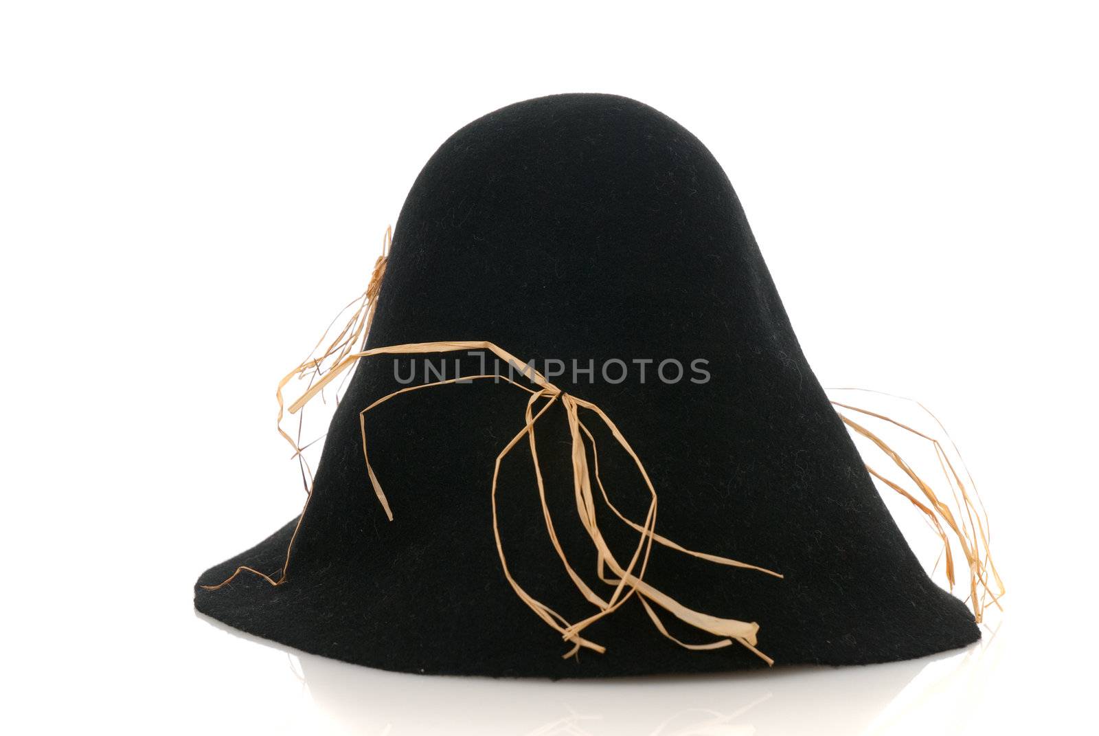 Scarecrow black felt hat with some straw isolated on white background.