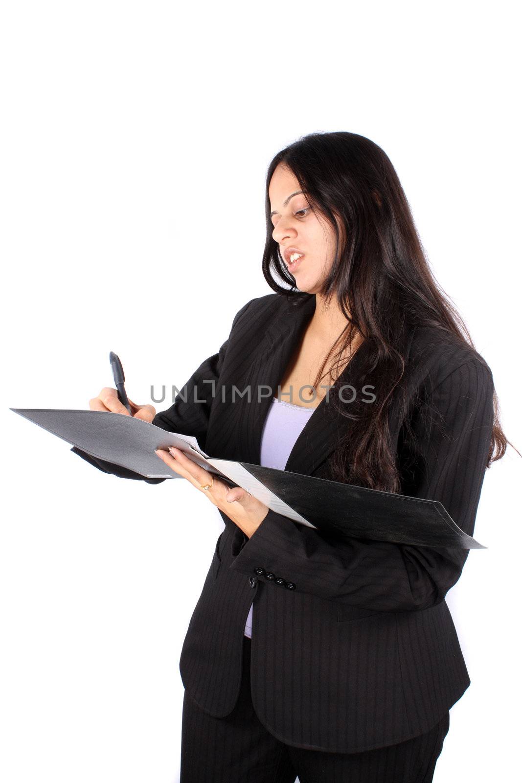 A smart Indian businesswoman signing a contract, on white studio background.