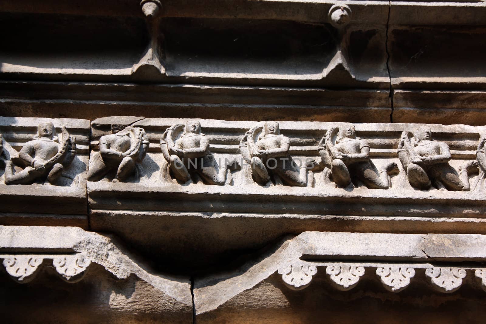 Artistically carved sculptures of Lord Krishna on the celing of a centuries old temple in India.