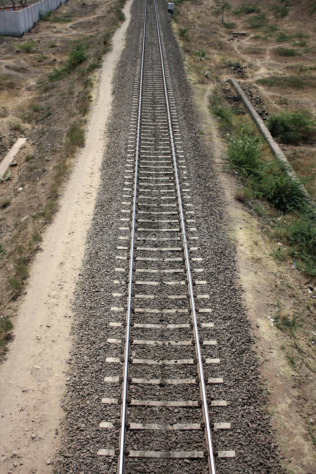 An aerial view of a straight railway track.