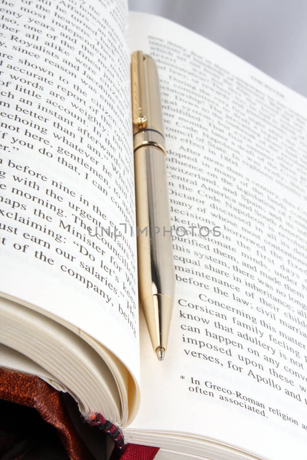 A open book and a golden pen in a university library.