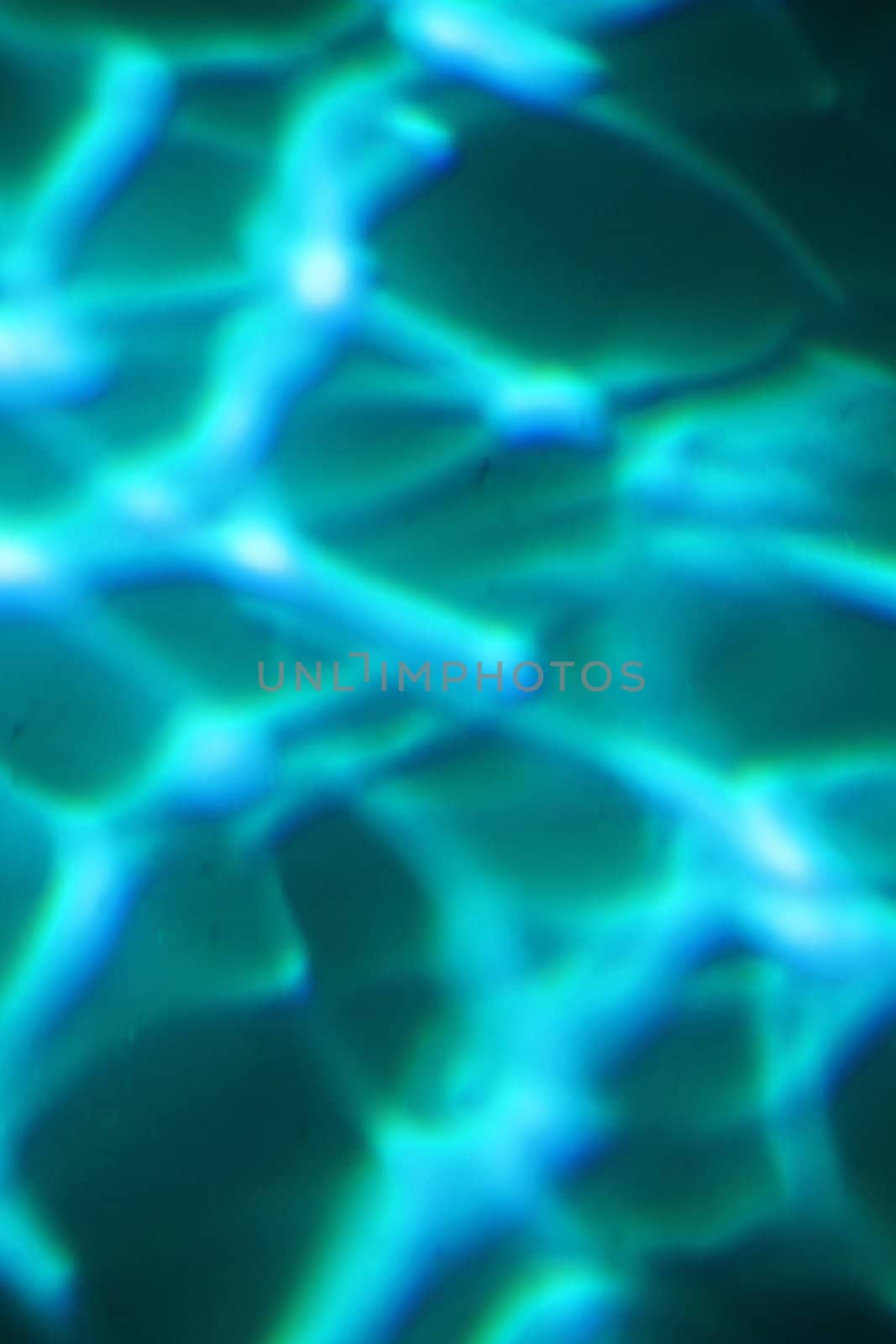 Abstract background of light shinning through blue water.