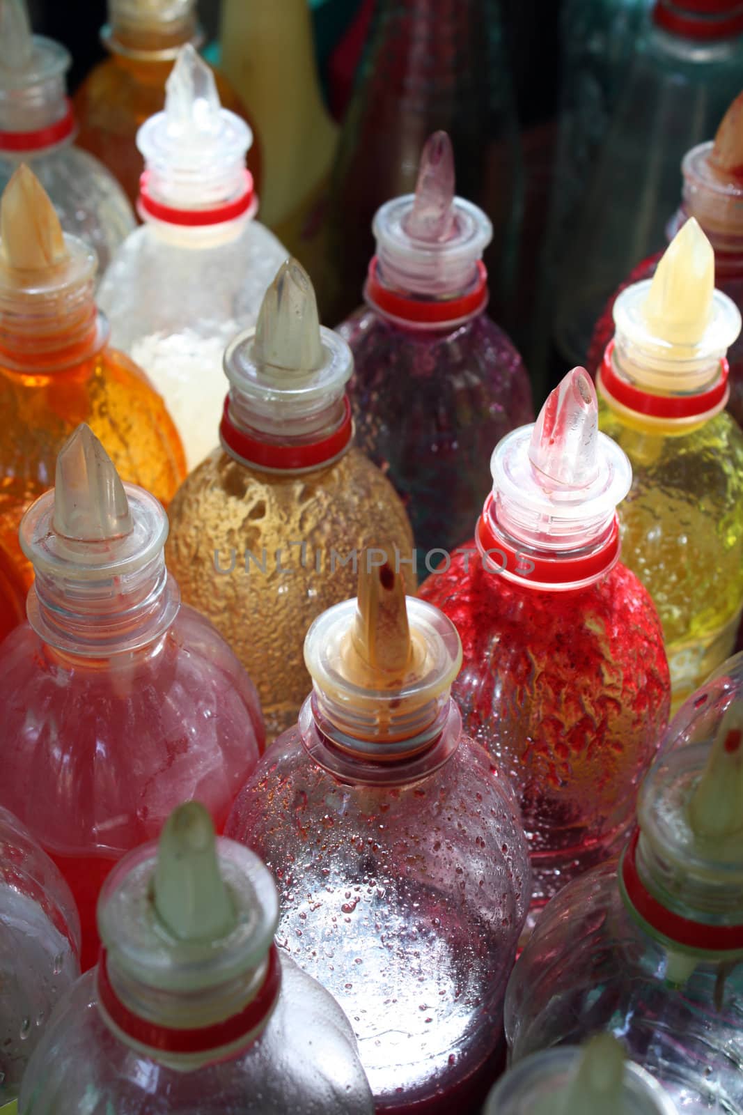 The colorful tester bottles of crush containing various fruity juices.