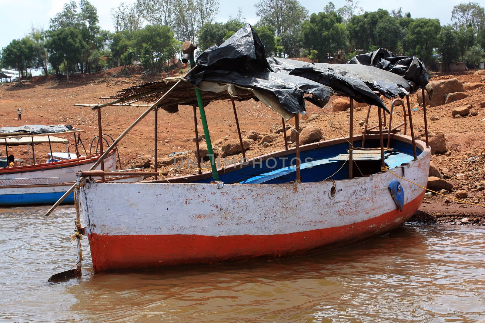 A boat anchored near a lakeside in India.