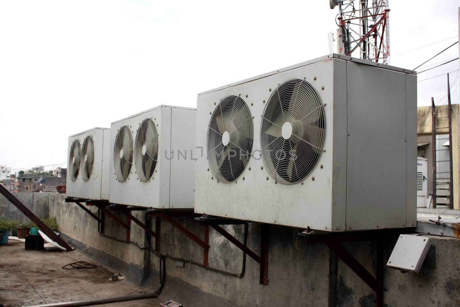 The condensor units of air conditioners installed on the top of a commercial building.