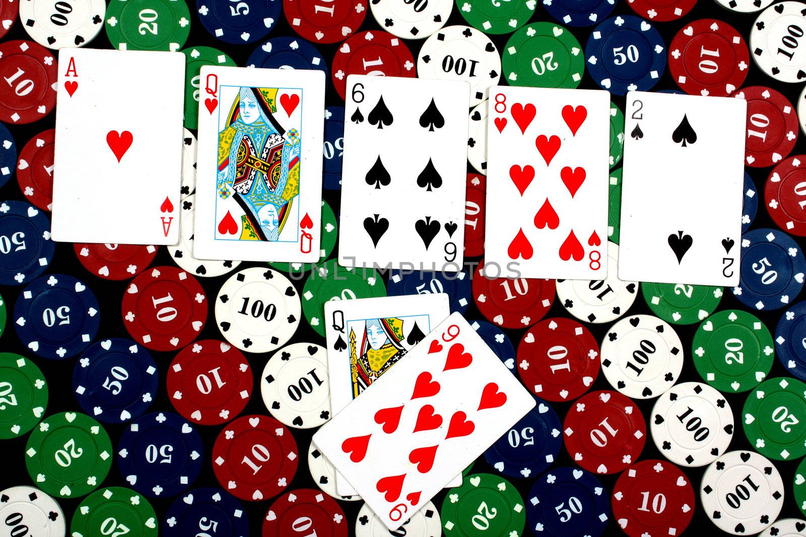 A poker hand of a pair of queens, on colorful gambling chips.