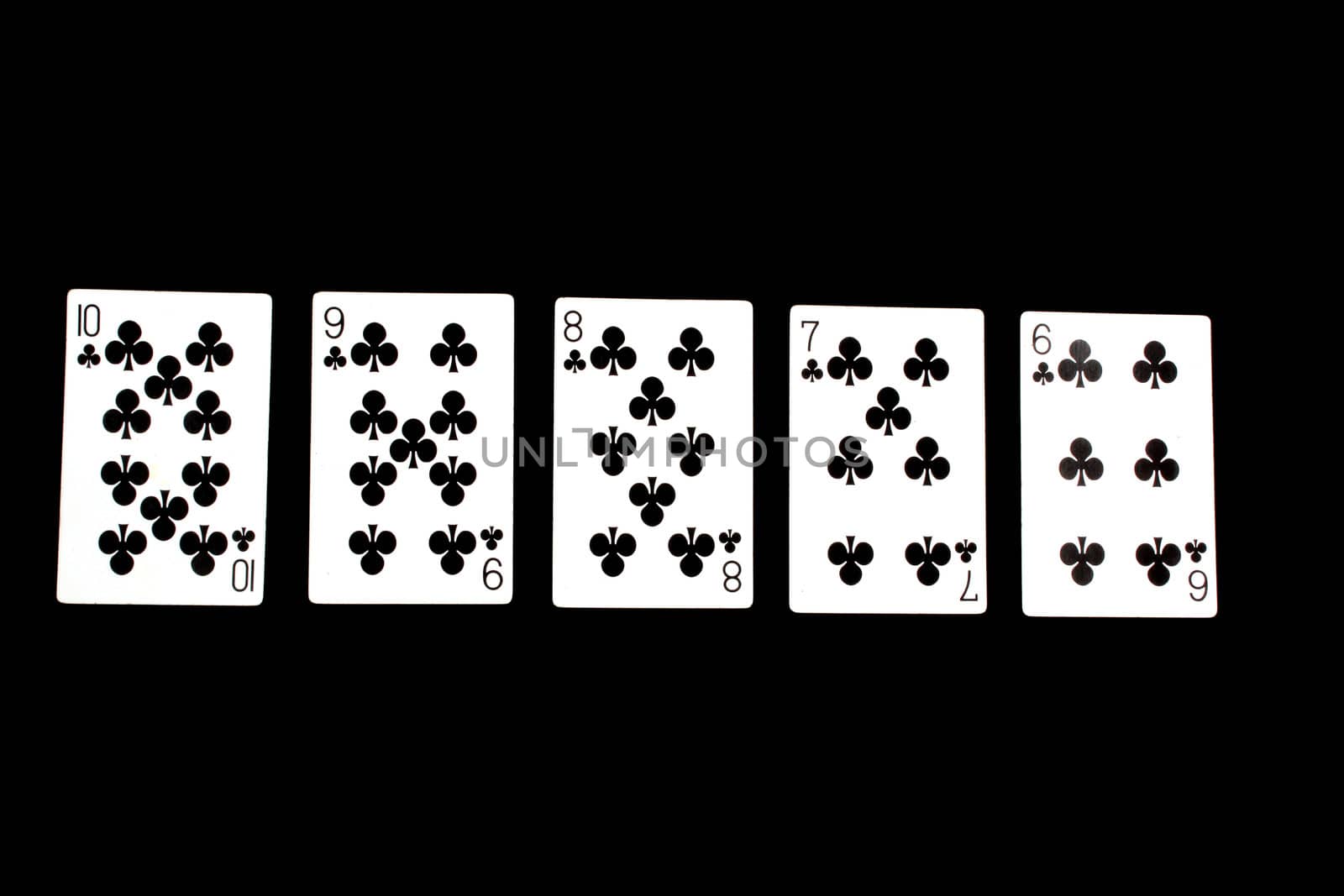 A poker hand of Straight Flush, on black studio background.