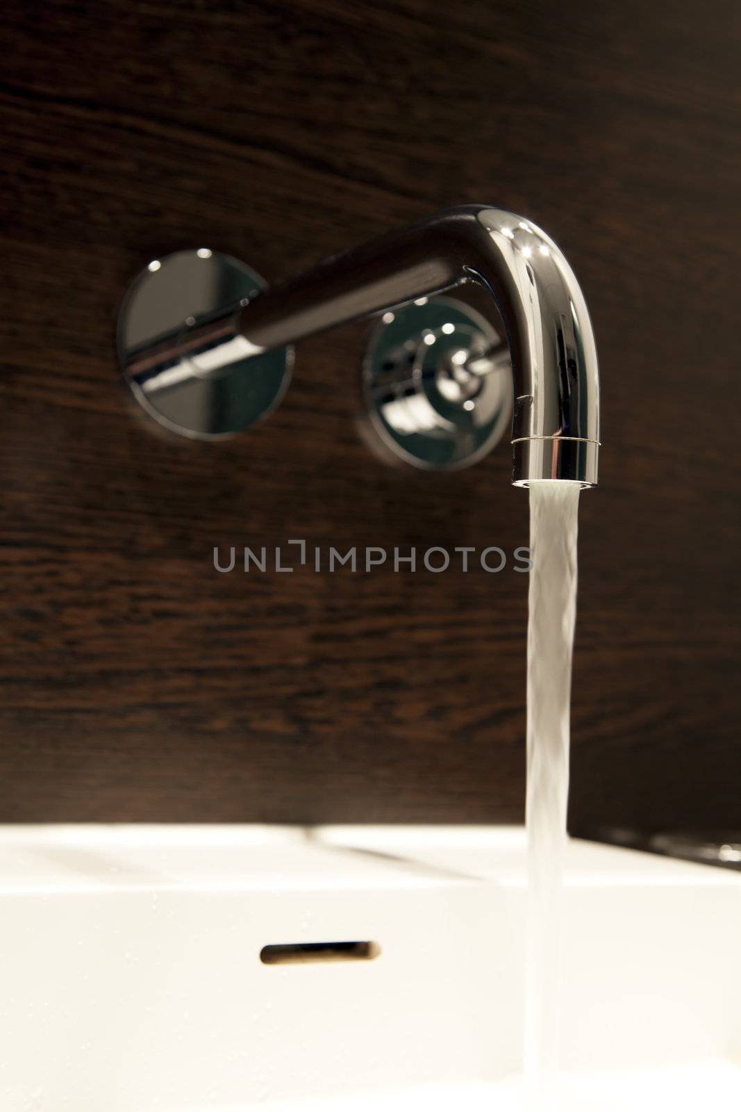 Bathroom faucet with running water.