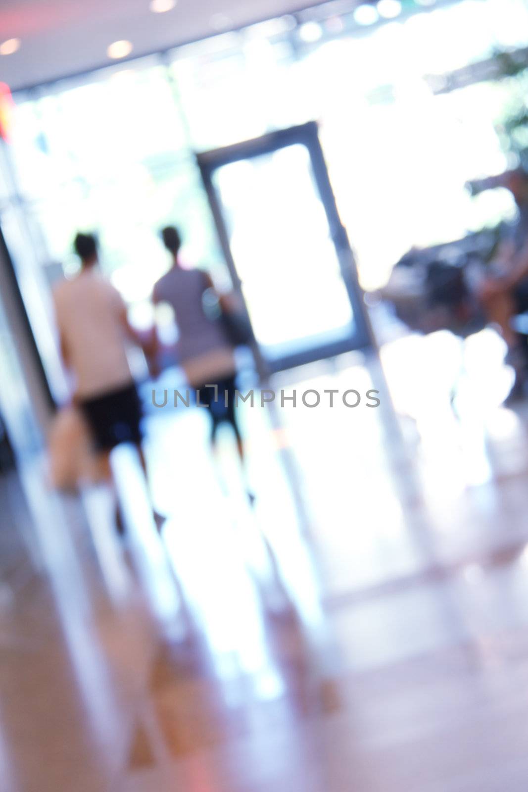 blurred unrecognizable people in motion in a shopping mall