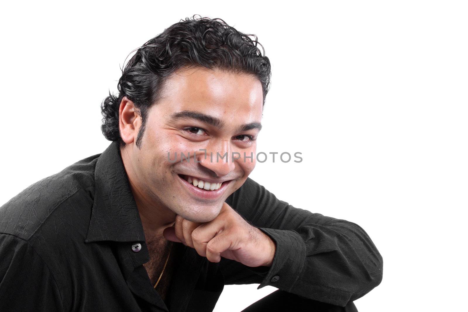A portrait of a happily smiling Indian guy, isolated on white studio background.