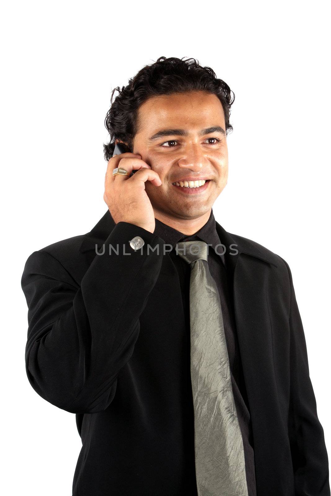 A young Indian businessman talking on the phone.