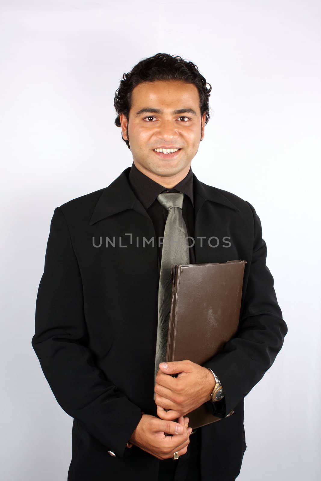 A handsome Indian businessman with a brown file / folder.