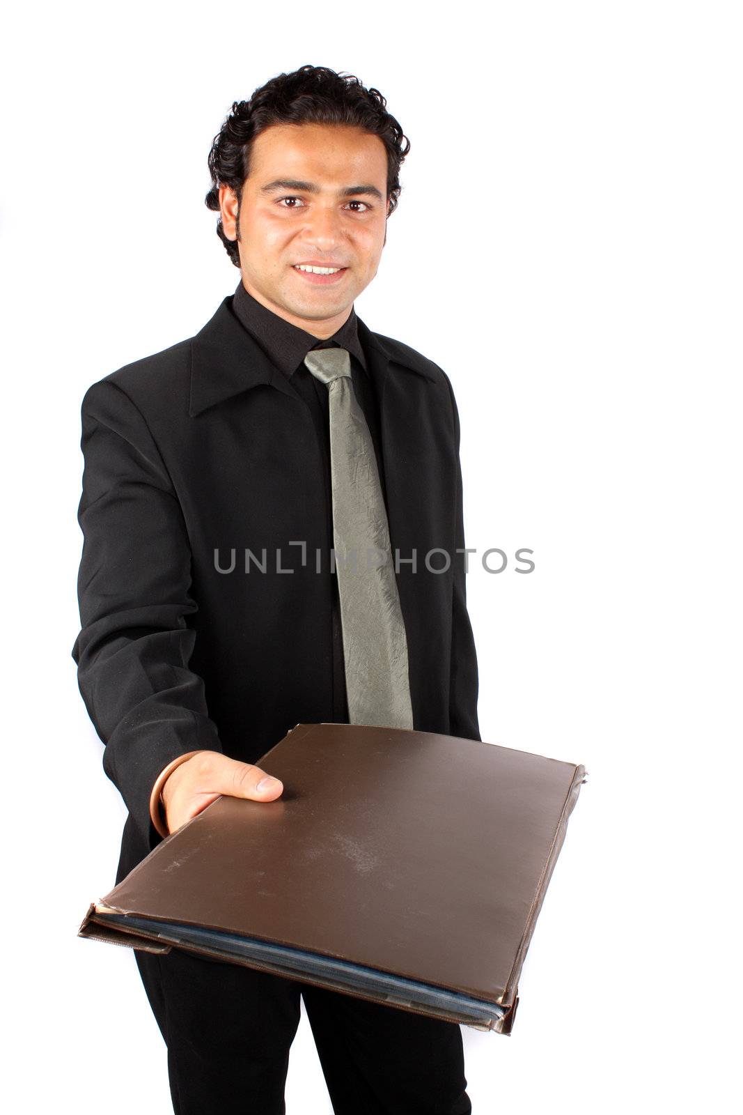 A metaphorical image of a happy Indian businessman handing over the file of a successful project, on white studio background.