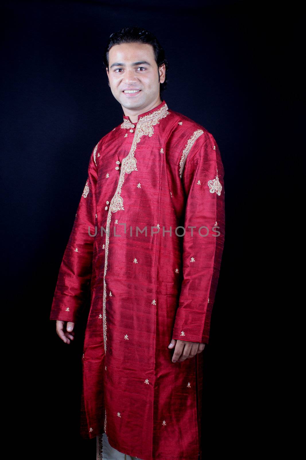 A handsome young Indian guy in a traditional attire.