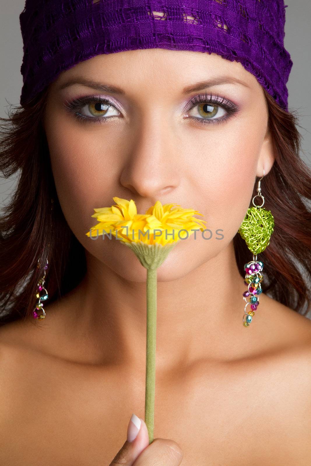 Beautiful woman smelling yellow flower