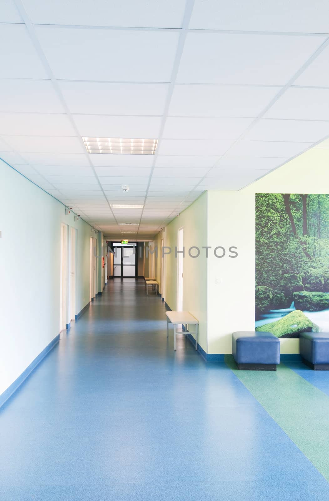Long corridor in hospital with doors and reflections 