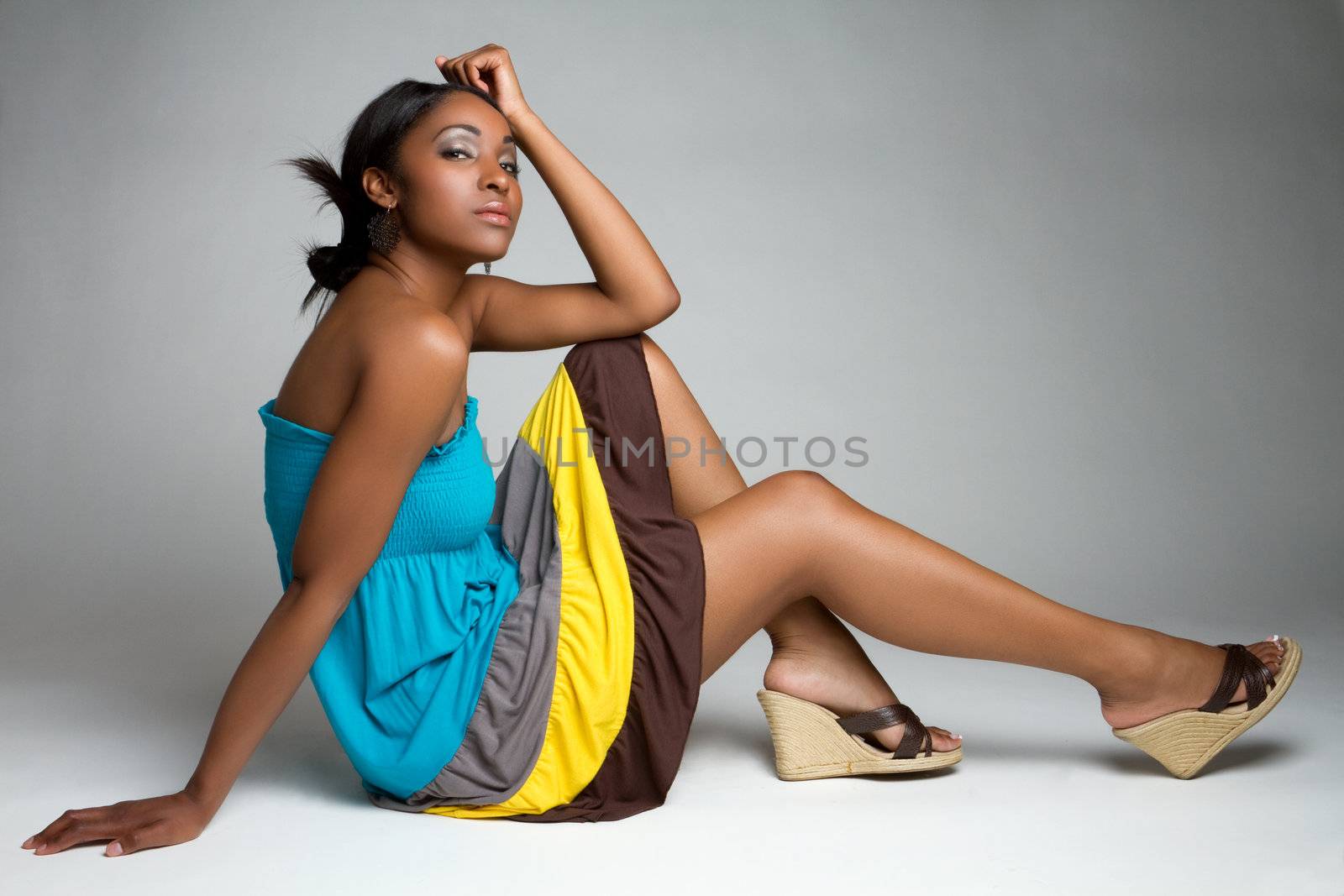 Beautiful black fashion woman sitting