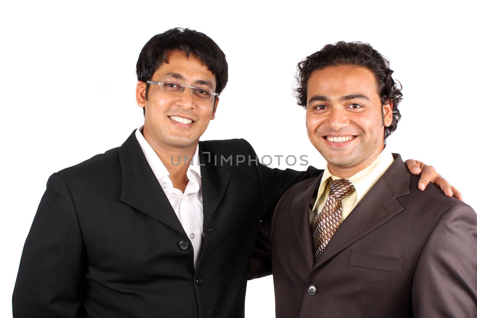 A portrait of a happy Indian businessmen after a successful deal, on white studio background.