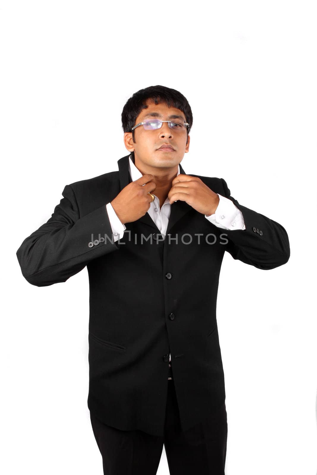 An Indina businessman getting ready, wearing his suit before his office, on white studio background.