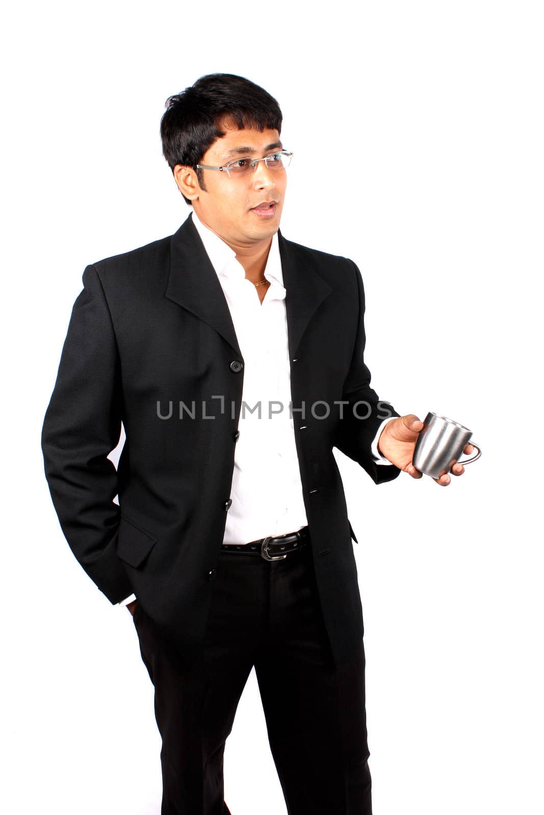 An Indian businessman holding a coffee cup in conversation, on white studio background.