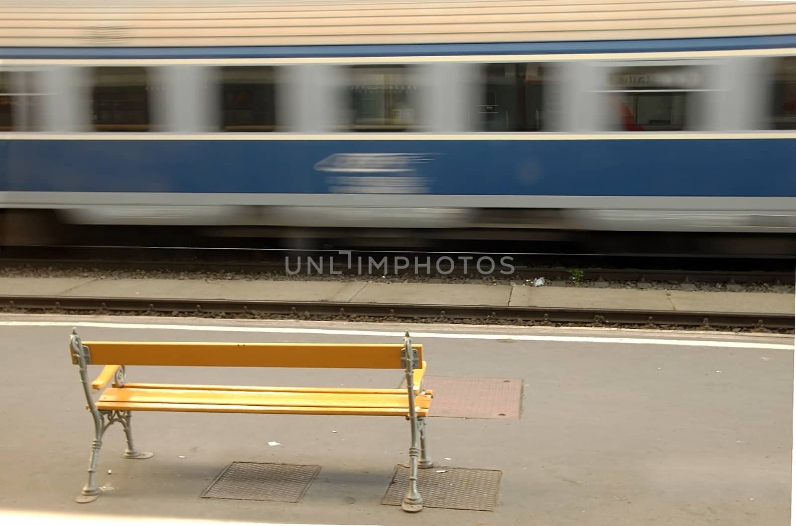 bench on railway station through the window of moving train