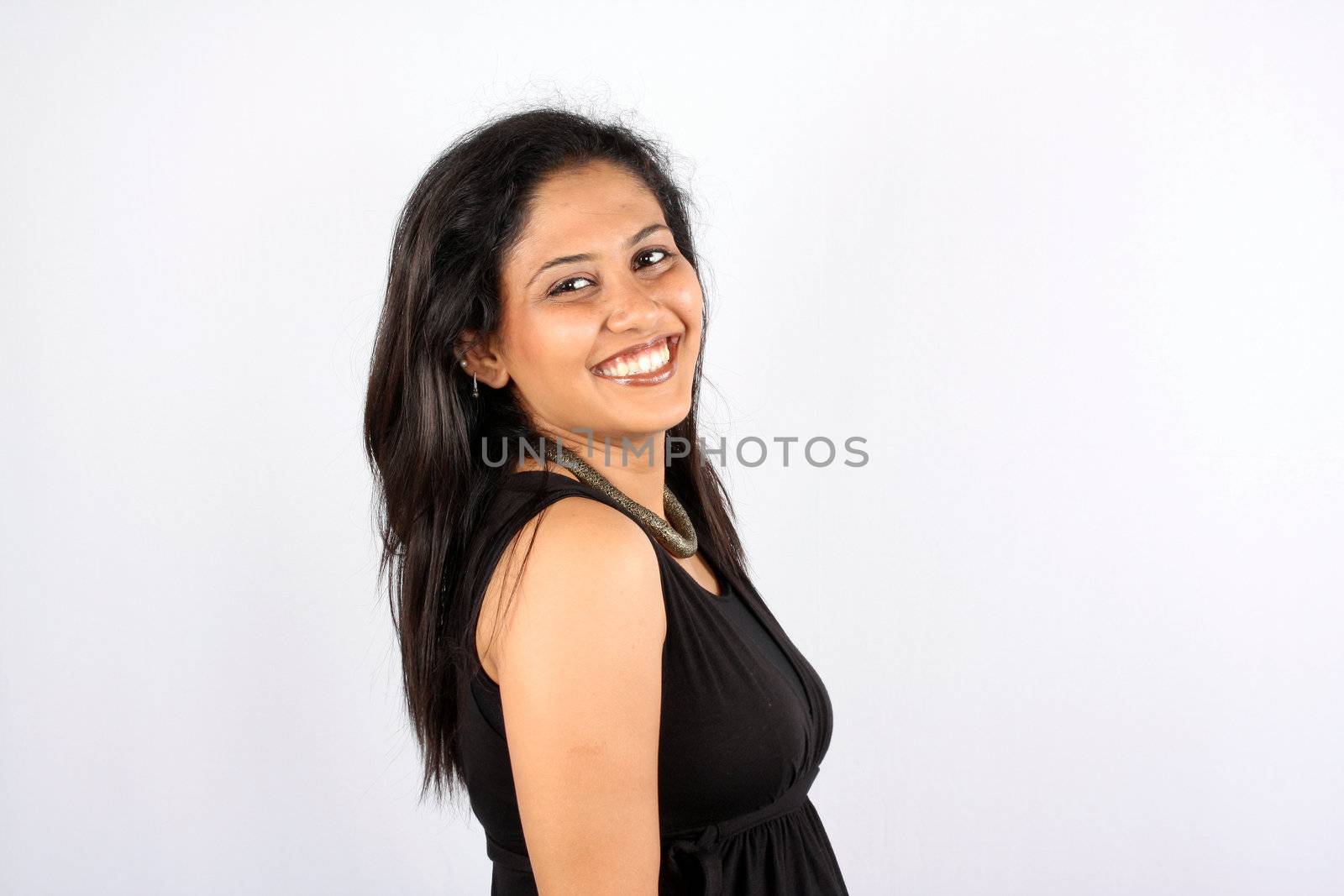 A pretty Indian woman, isolated on white studio background.
