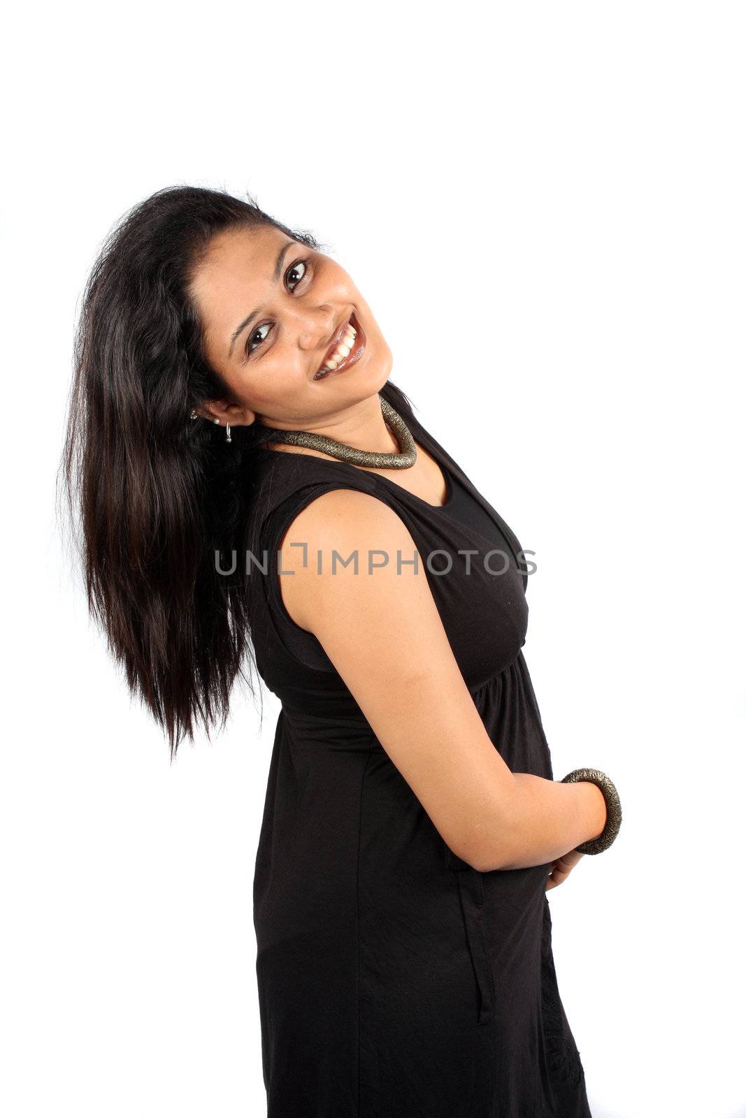 A beautiful Indian woman in black dress in a happy mood, on white studio background.
