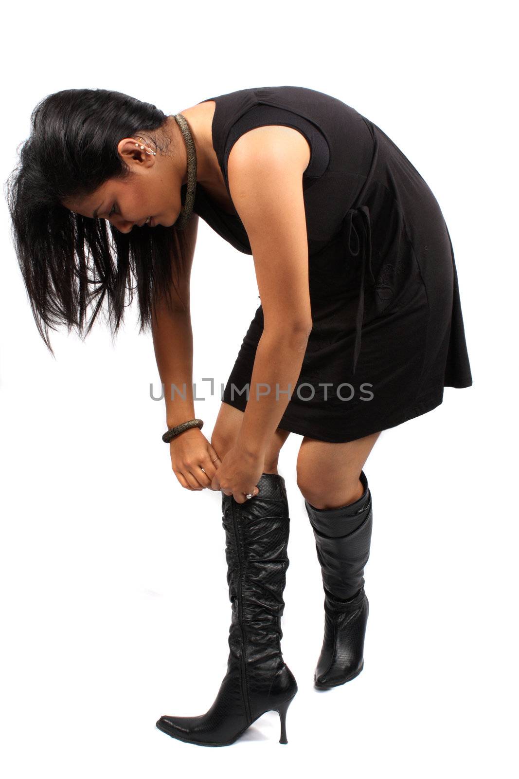 An Indian model wearing fashionable boots, on white studio background.