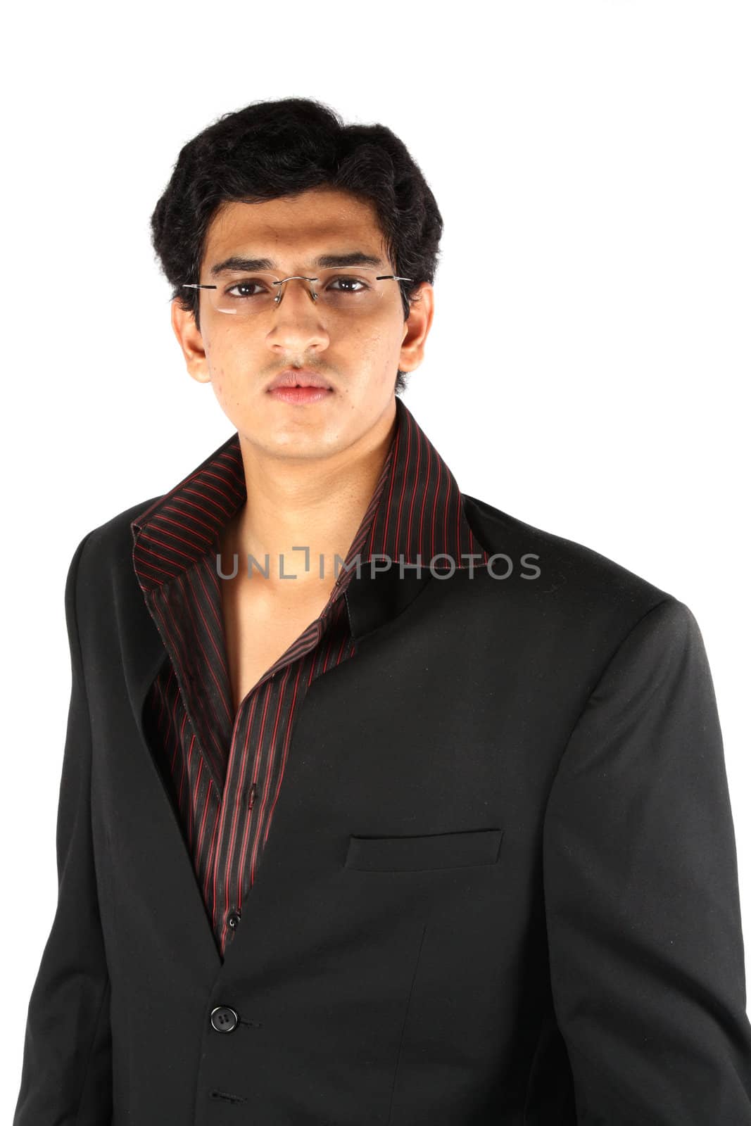 A portrait of a young Indian businessman in a suit, on white studio background.