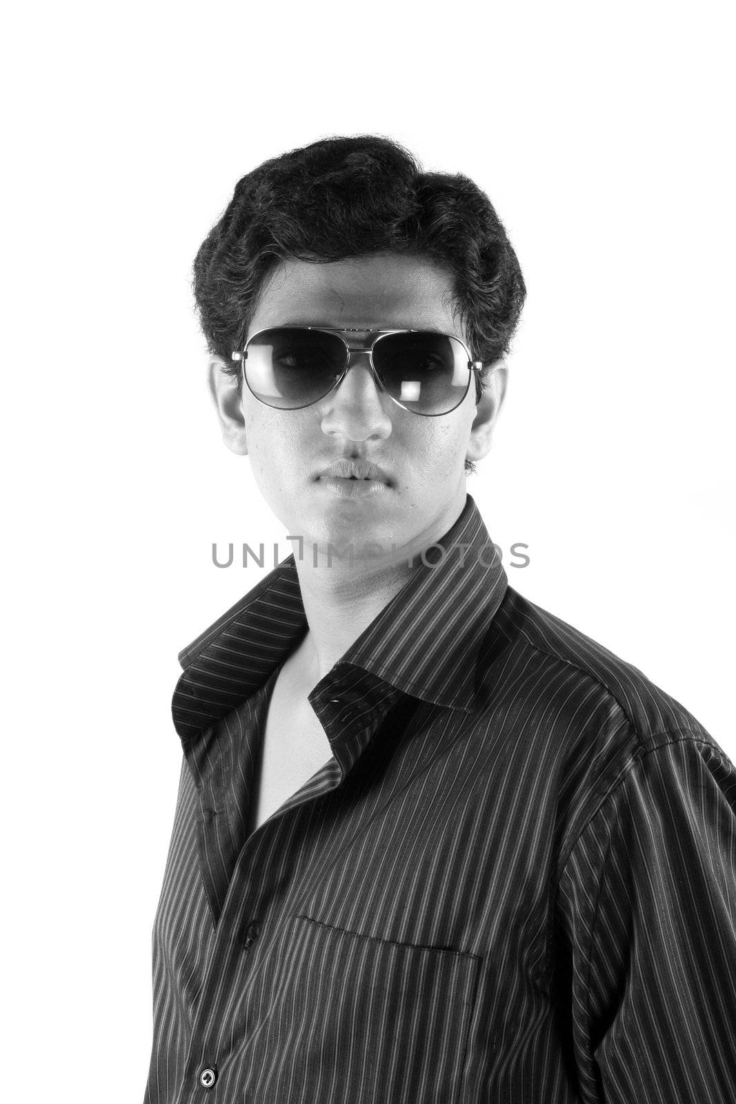 A black & white portrait of a young n' handsome Indian guy, on white studio background.