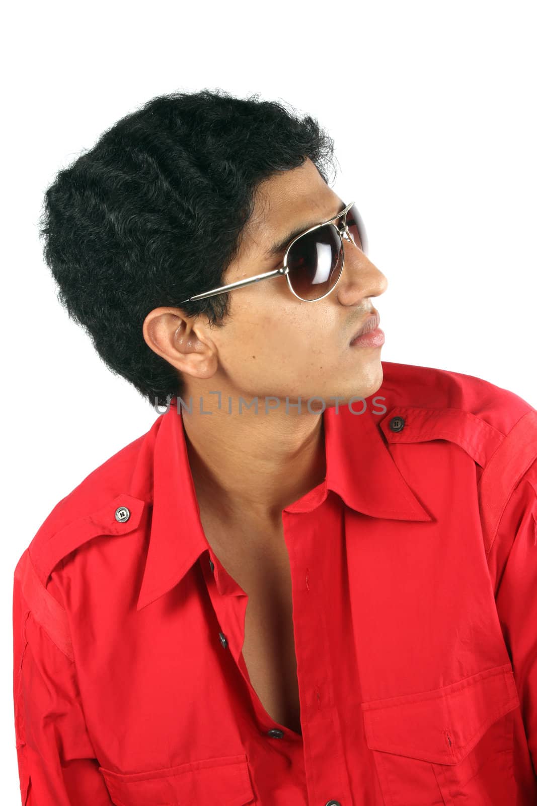 A portrait of a handsome Indian teenage guy, on white studio background.